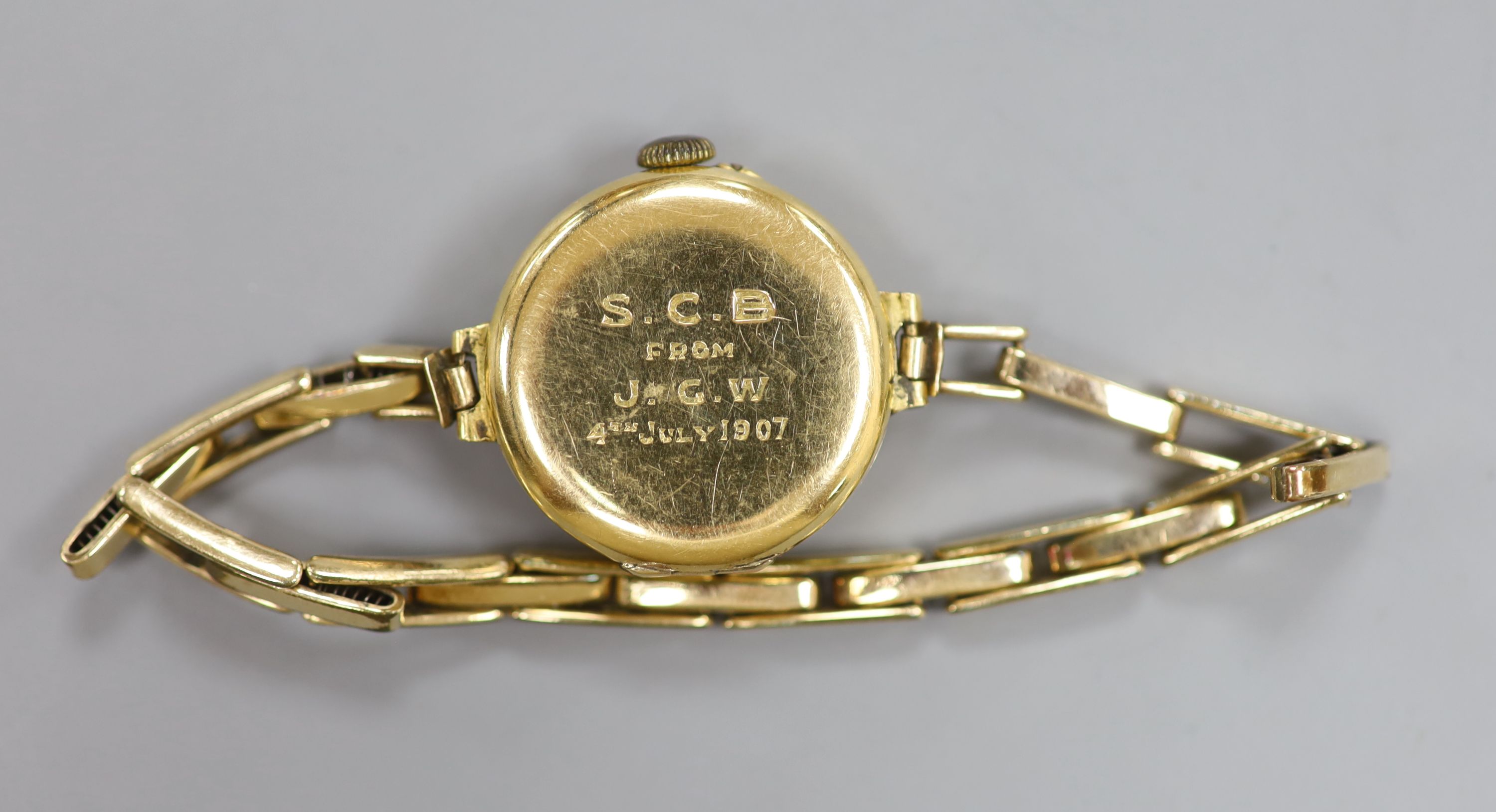 A ladys early 20th century continental 18c yellow metal manual wind wrist watch on gold plated bracelet, gross 22.3 grams,